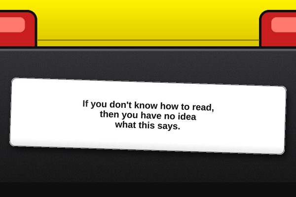 If you don't know how to read, then you have no idea what this says. bumper sticker on a car bumper